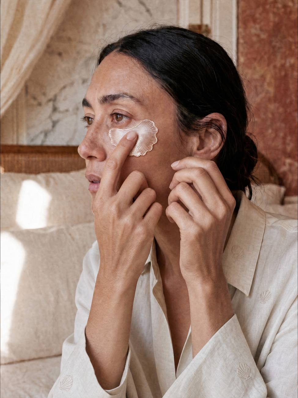 Woman applying the shell patch beneath her eye