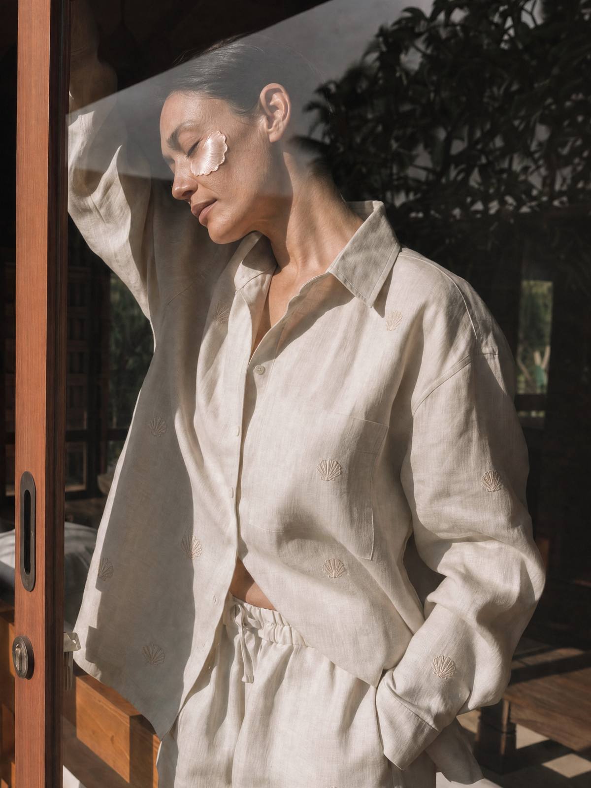 Woman resting against a doorway in soft afternoon light